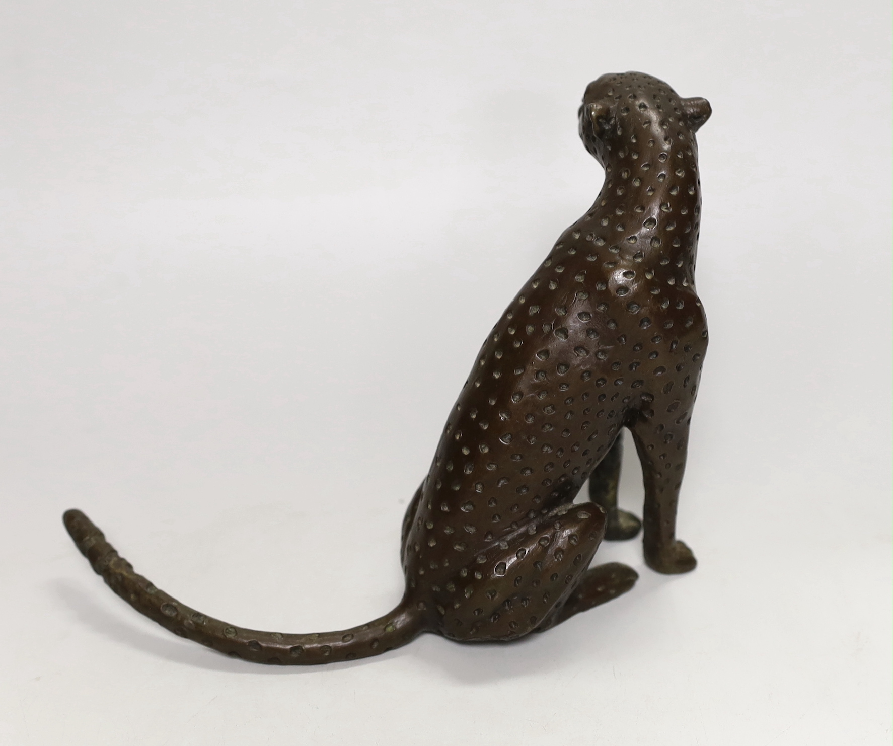 A small contemporary bronze seated leopard, stamped and dated 2000 to underside, 15cm high